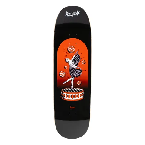 Welcome Ryan Reyes Dancer on Baculus 2.0 - Black skateboard deck: A winged ballerina in a dark tutu balances on one pointe on a checkerboard-topped round plinth, surrounded by floating striped orange planets in an arched red-orange panel on a black board, with a gothic Welcome logo above and 'Reyes' below.