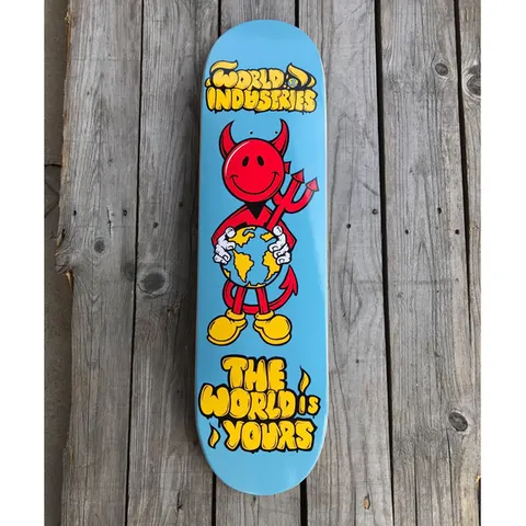 World Industries DevilMan - The World is Yours skateboard deck: Smiling red devil character with a trident, wearing yellow shoes and hugging a globe, on a light blue deck. World Industries logo is at the top and 'The World is Yours' in yellow bubble lettering at the bottom.
