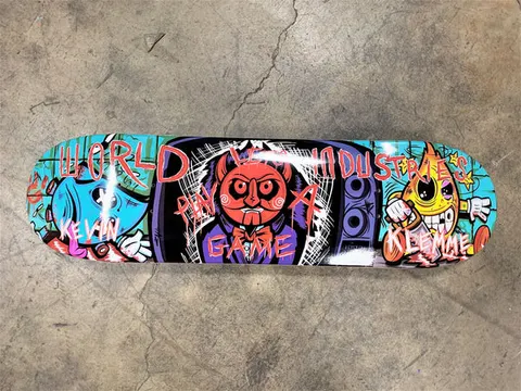 World Industries Kevin Klemme Saw Boys skateboard deck: Three crudely drawn cartoon characters across the deck, a blue figure, a red devil with swirling eyes in a bow tie beside a speaker, and a yellow one-eyed flame figure, with red scrawled lettering over them.