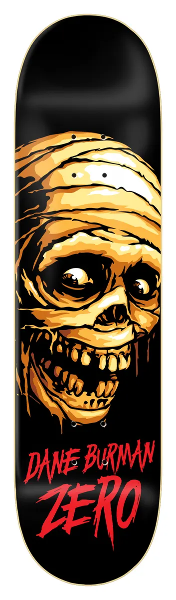 Zero Burman - Mummy 8.5 skateboard deck: Black deck with a large bandaged mummy head in orange and yellow tones with bulging eyes and a gaping toothy grin. Rider name and brand in red drippy lettering at the bottom.