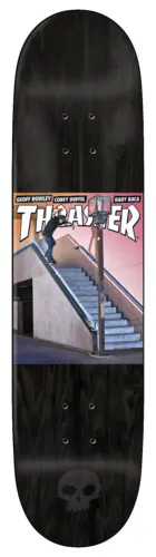 Zero Thrasher Cover - Burman skateboard deck: Black stained deck with a Thrasher magazine cover recreated mid-deck, showing a skater doing a board slide down a long handrail beside concrete steps. Small Zero skull logo at the tail.