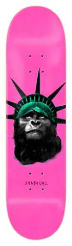 Zero Iconoclash - Sandoval skateboard deck: A black and white gorilla head wearing the green spiked crown of the Statue of Liberty, on a hot pink deck, with the rider name in handwritten text below.