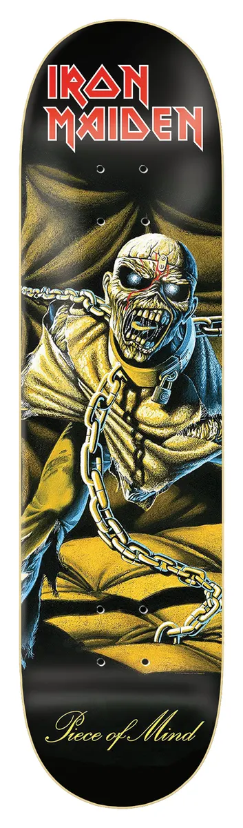 Iron Maiden Iron Maiden - Piece Of Mind skateboard deck: Painted album-cover artwork of a gaunt, chained zombie-like figure with glowing eyes and a red mark on its forehead, sitting in a yellow padded cell. Red band logo at top on black.
