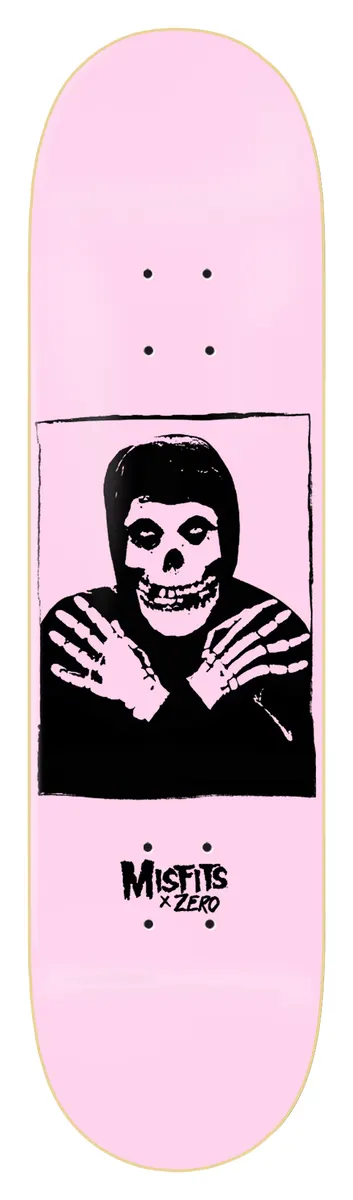 Zero Misfits Fiend - Light Pink (Limited Edition) skateboard deck: Light pink deck with a black print of a skull-faced Misfits figure in a hooded top with arms crossed, in a square frame, with the Misfits x Zero logo below.