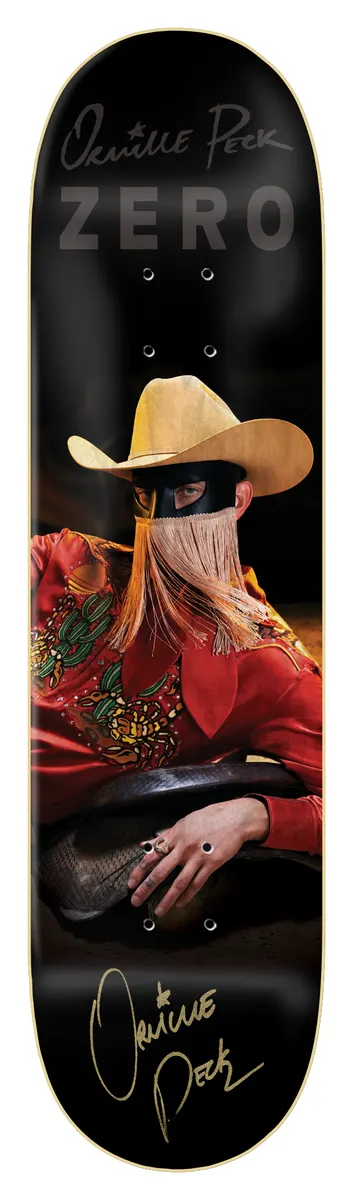 Zero Orville Peck - Bronco *signed* skateboard deck: A photographic portrait of a masked figure in a cream cowboy hat with a long fringe over the face, wearing a red embroidered western shirt and resting on a saddle. Gold signature and name printed above and below on a black deck.