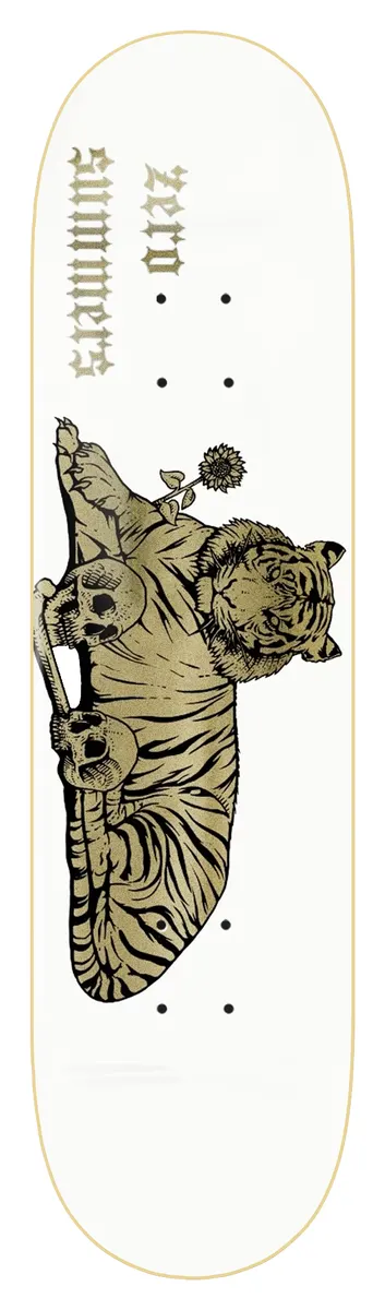 Zero Summers - Tiger 8.4 skateboard deck: A gold-printed tiger lies down with its paws resting on two skulls and a flower in its mouth, on a white deck. Gothic lettering with the rider name and Zero runs upside down near the nose.