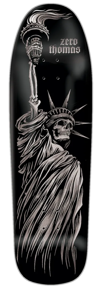 Zero Thomas - Liberty Or Death 9.5 Cruiser skateboard deck: Monochrome silver-on-black illustration of a skeletal Statue of Liberty, with a skull face and bony raised arm holding a torch, drawn in fine engraved linework. Rider name set in gothic lettering at the top beside the torch.