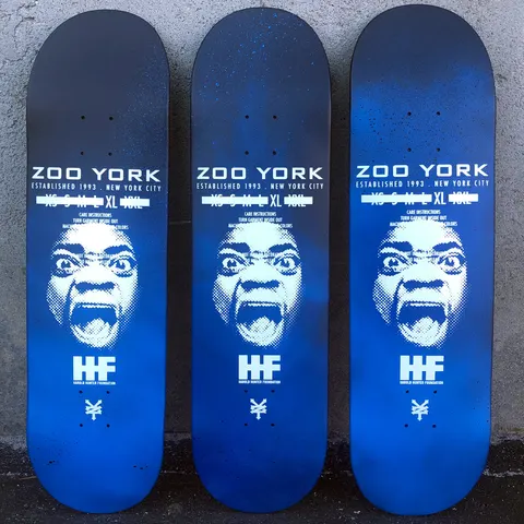 Zoo York Harold Hunter Spray Faded skateboard deck: A halftone white portrait of a screaming face under the Zoo York name and clothing-label style text, above a Harold Hunter Foundation logo and the Zoo York mark, on a black to blue spray-faded ground. Three decks shown with slightly different fades.
